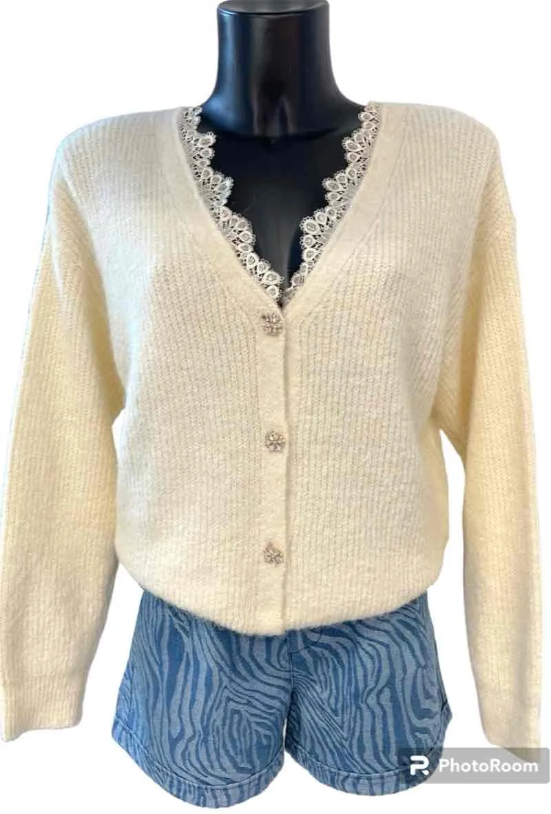 Short soft knit cardigan. lace finish on the collar and jeweled buttons